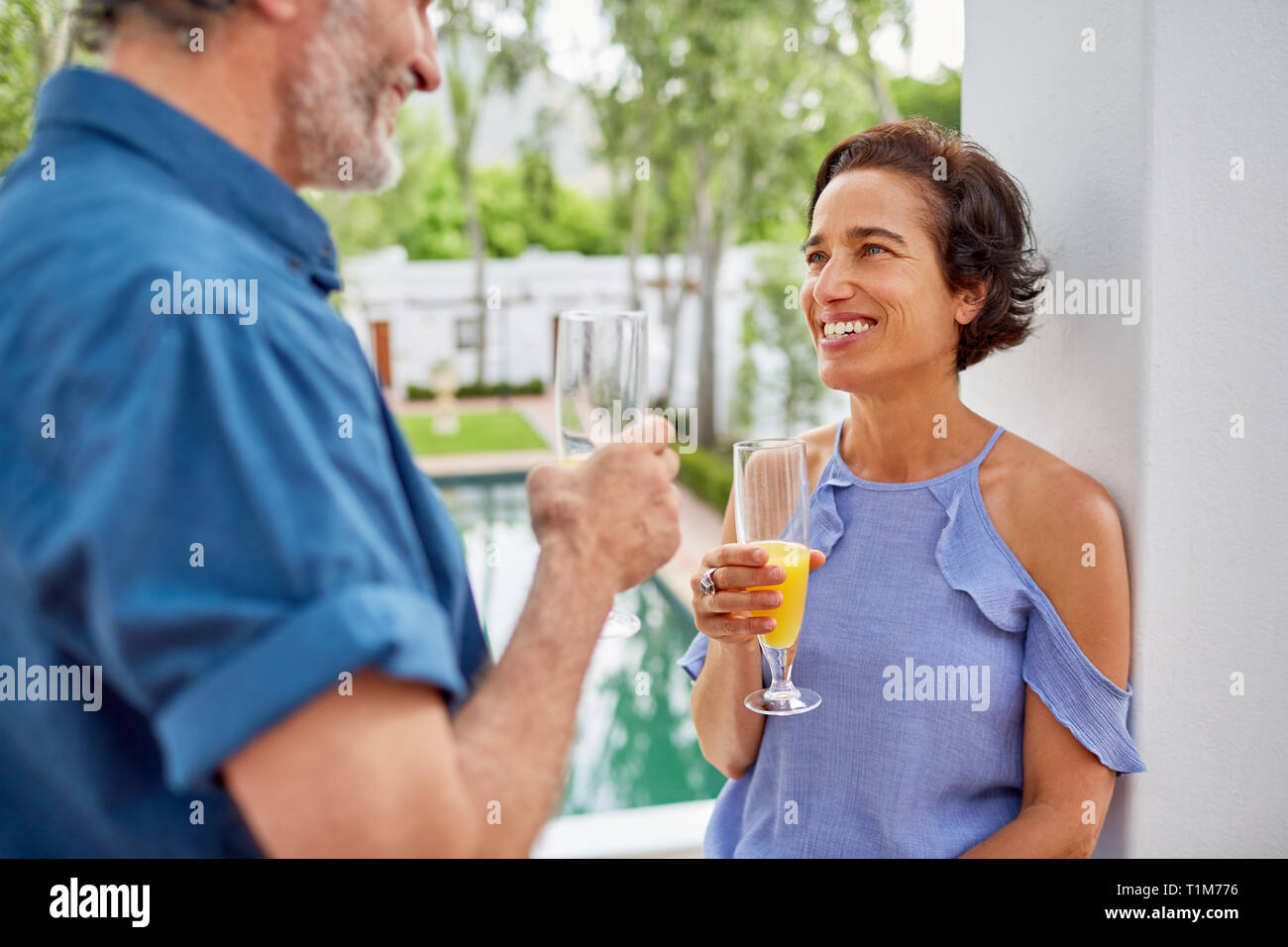 Gerne reifes Paar trinken Mimosen auf hotel Balkon Stockfoto