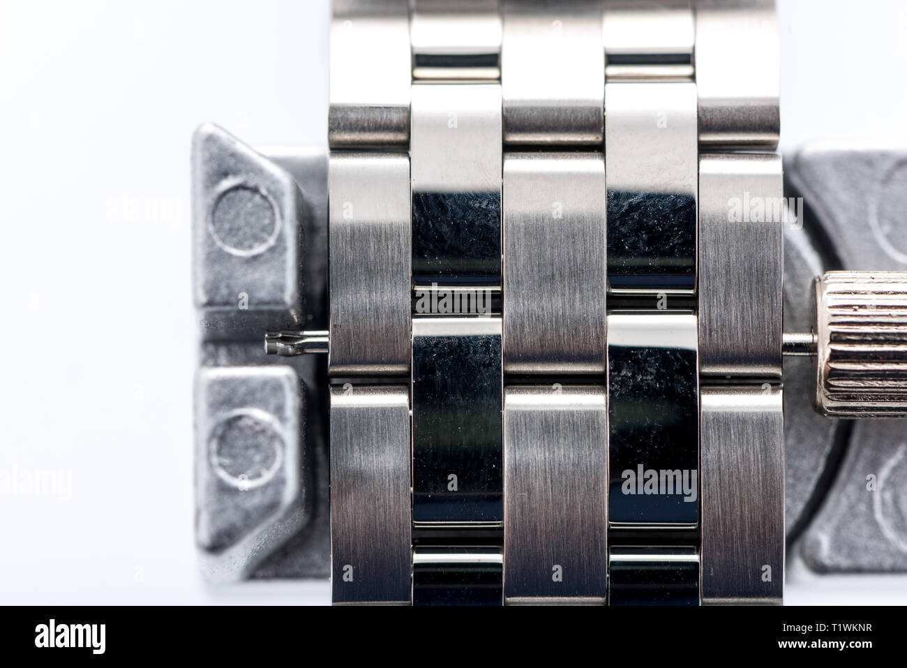 Eine Uhr pin aus Armband mit Uhr link Ausbauwerkzeug an einem isolierten Hintergrund gedrängt. Stockfoto