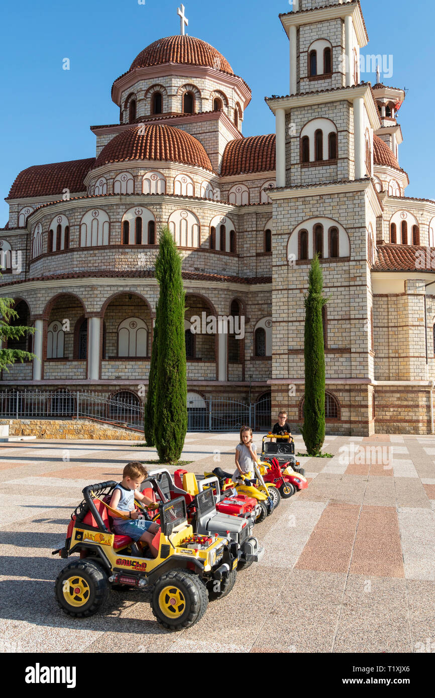 Kinder spielen auf miniatur Autos vor der Orthodoxen Kathedrale und Korca Korca, Südosteuropa Albanien. Stockfoto