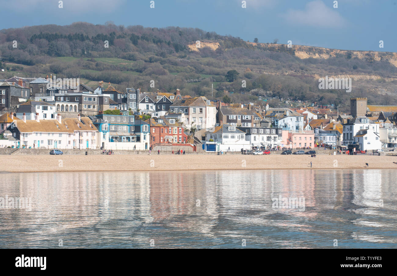 Lyme Regis, Dorset, Großbritannien. 29. März 2019. UK Wetter: Ein weiterer Tag der Sonne und strahlend blauen Himmel als Badeort von Lyme Regis in den frühen Frühling Hitzewelle weiter. Die malerischen Gebäude sind in den ruhigen Wasser wider. Credit: Celia McMahon/Alamy leben Nachrichten Stockfoto