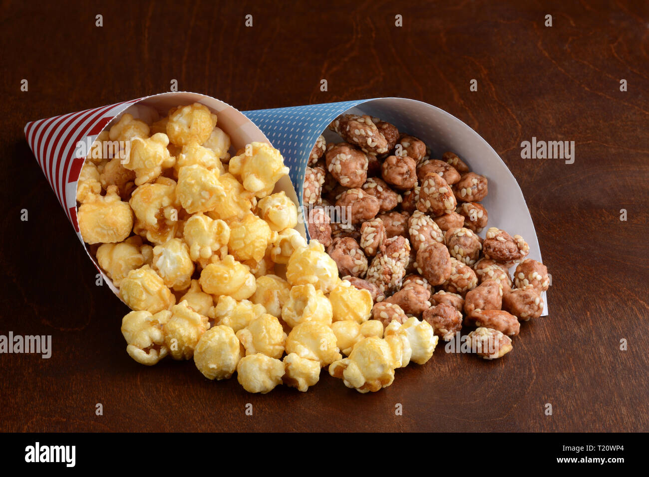 Karamell Popcorn und Honig Sesamsamen Mandeln in Papier Kegel Stockfoto