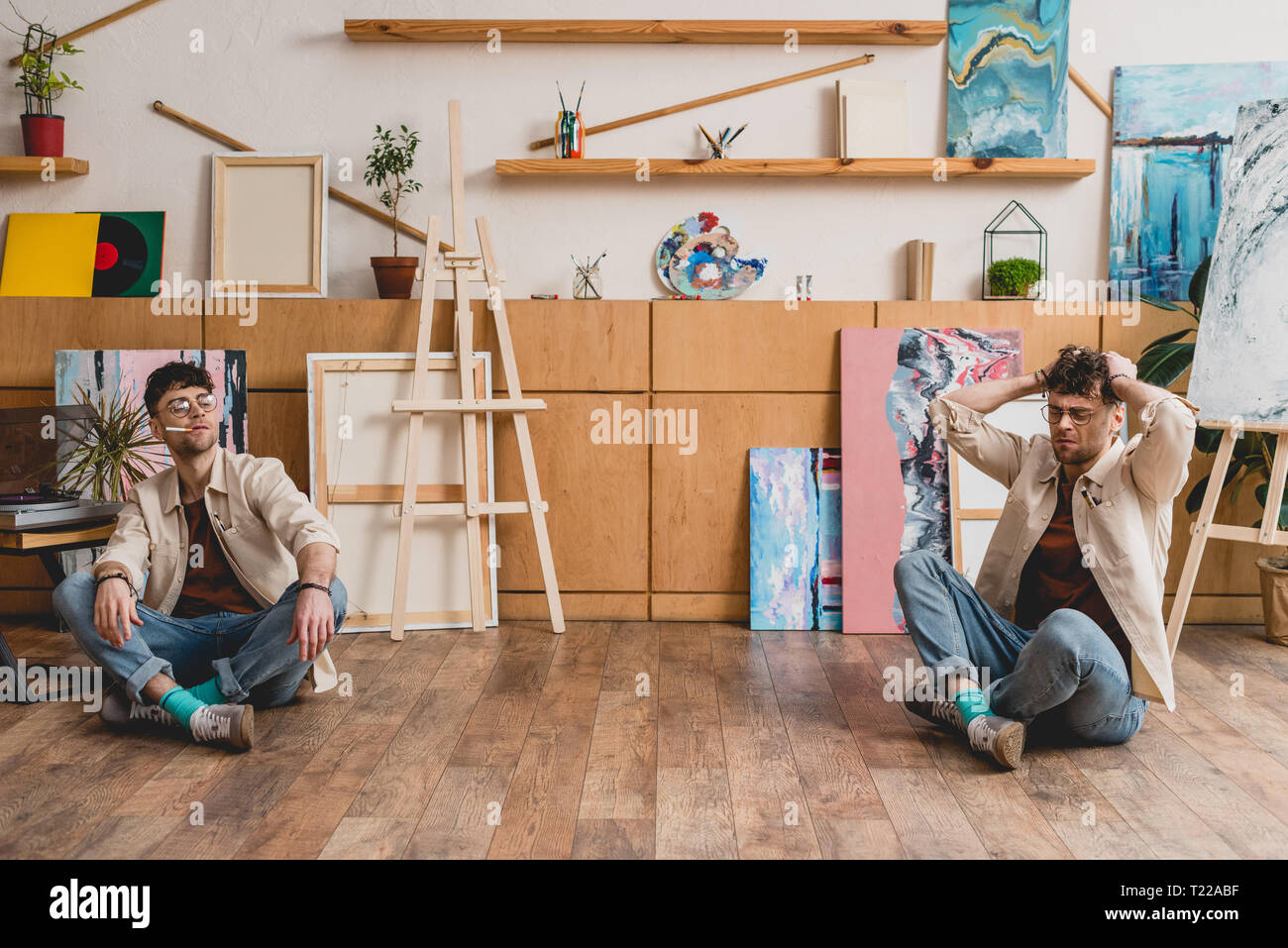 Mehrfachbelichtung von Künstler sitzen auf dem Boden in der Malerei studio Stockfoto