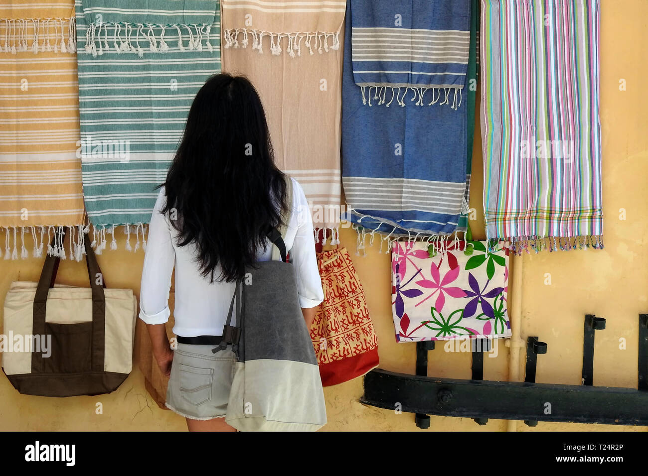 Weibliche touristische Shopping/am Strand Handtücher in Korfu, Griechenland suchen Stockfoto