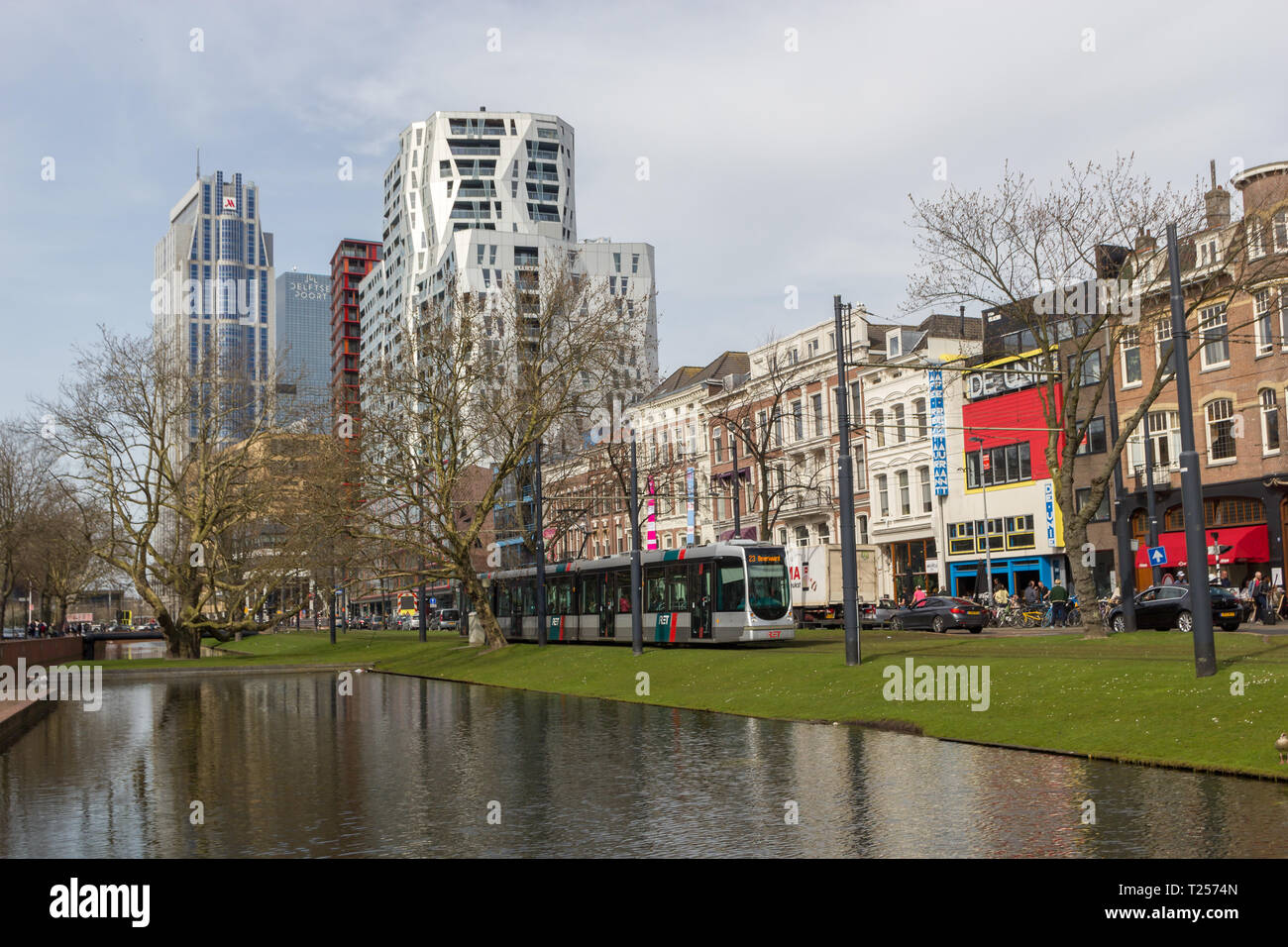 Rotterdam, Niederlande - 7 April 2018: Moderne und alte Architektur des Stadtzentrums von Rotterdam mit Straßenbahn, Reflexionen über den Kanal, Brücke und Grün ar Stockfoto