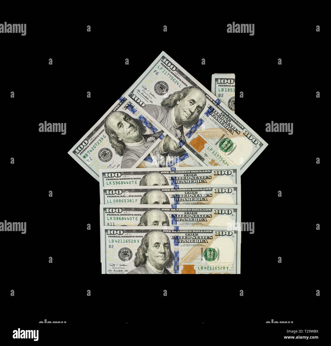 Hypothek und Property Investment Konzept. US Dollar Geld Bargeld Modell des Hauses auf schwarzem Hintergrund Stockfoto