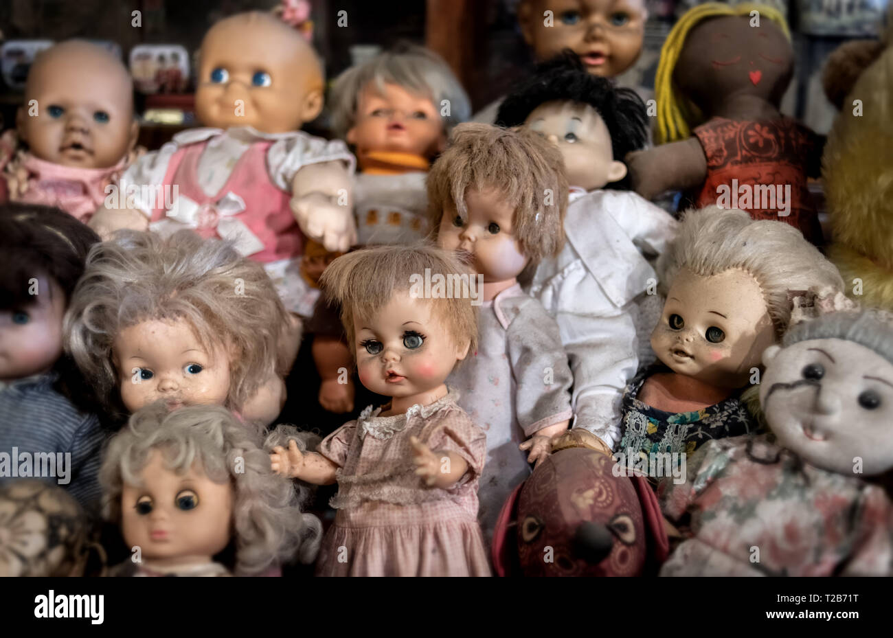 Vintage baby dall Spielzeug Sammlung Gruppe mit Innen sehr geringe Beleuchtung und Schatten Stockfotografie Alamy