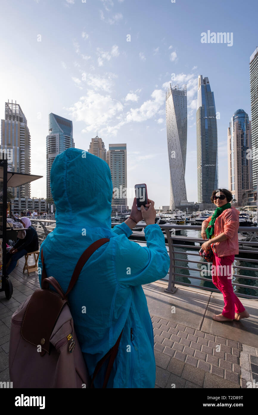 Asiatische Touristen für Fotografien in der Dubai Marina, Dubai, Vereinigte Arabische Emirate posing Stockfoto