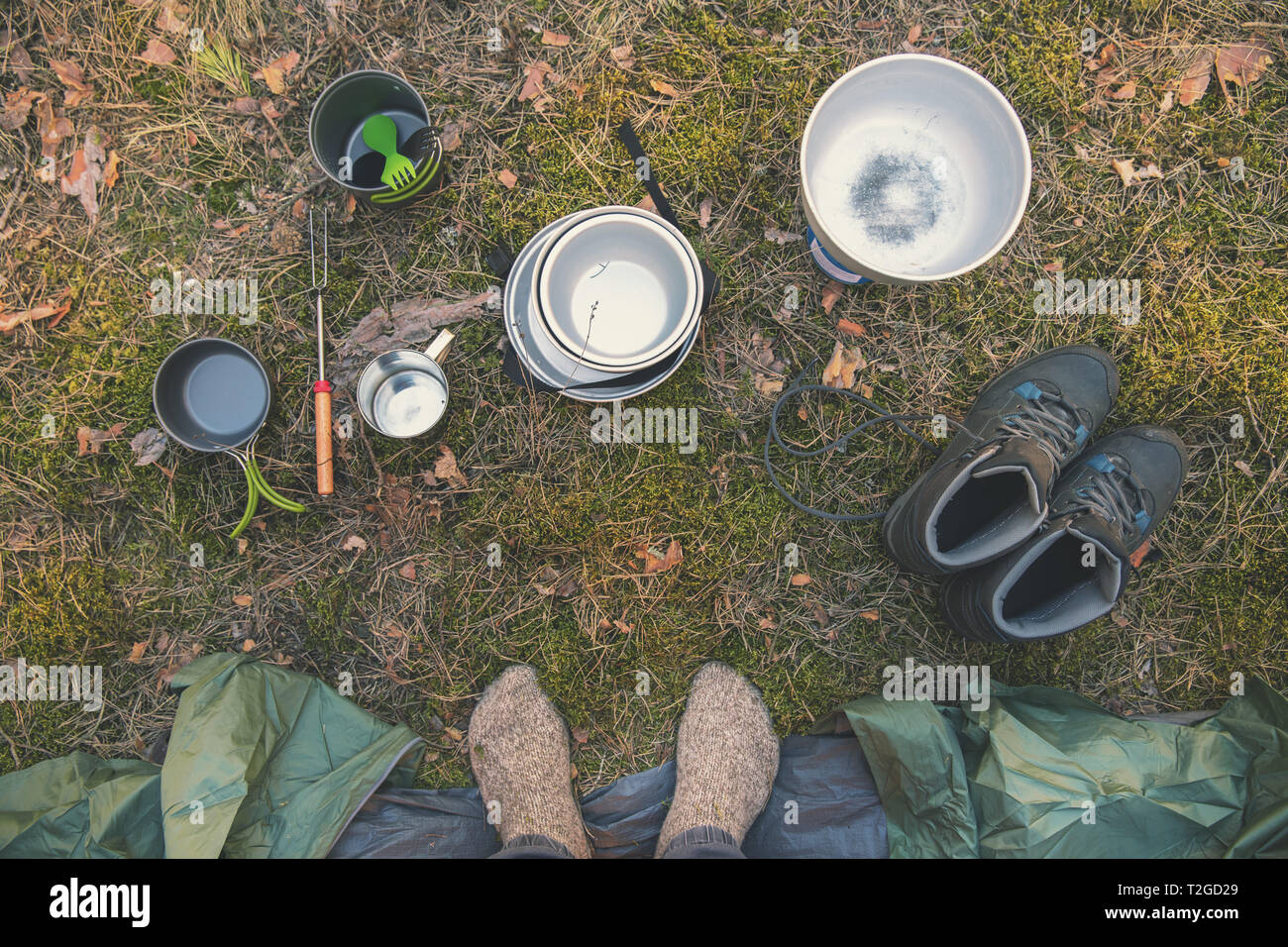 Campingausrüstung und traveler Füße durch das Zelt. top View Stockfoto