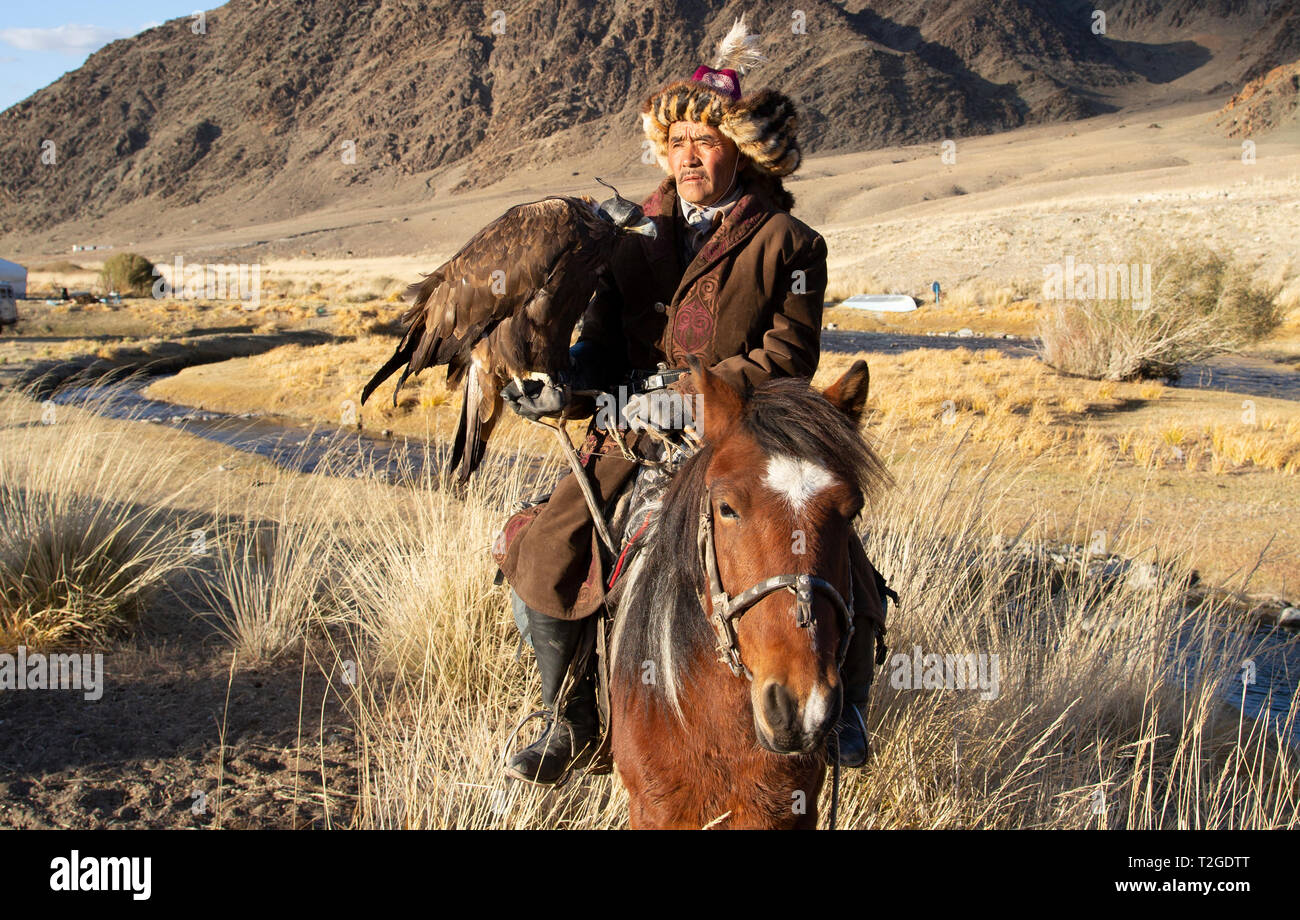 Bayan Ulgii, Mongolei, 2. Oktober 2015: kazak Eagle Hunter in traditioneller Kleidung auf seinem Pferd Stockfoto