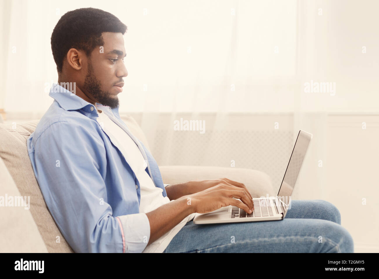 Einstellung Konzept. African-american Guy surfen Arbeitsmöglichkeiten online Job search App oder Website auf Laptop, leeren Raum Stockfoto