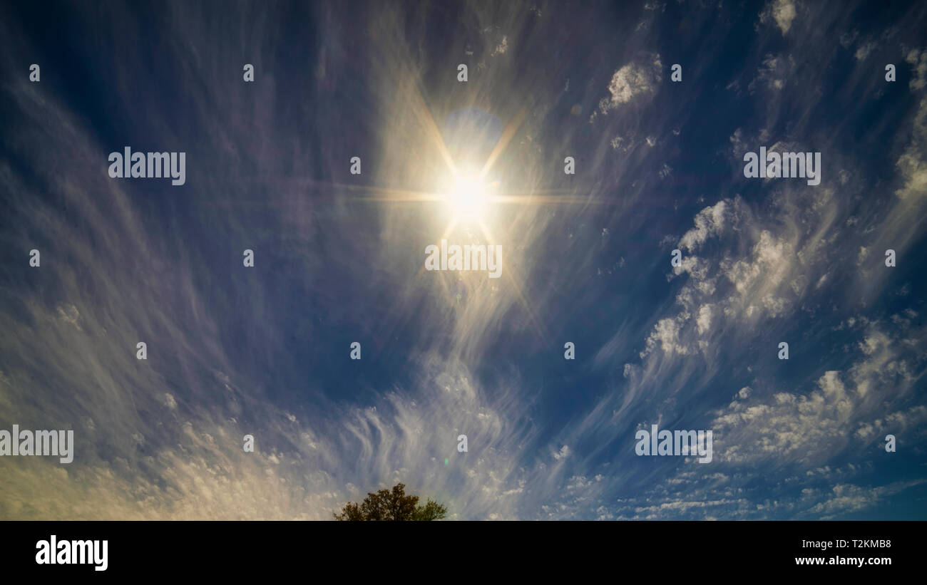 Die Kombination von Sonne, blauem Himmel, und wispy Wolken sorgen für interessante Muster. Stockfoto