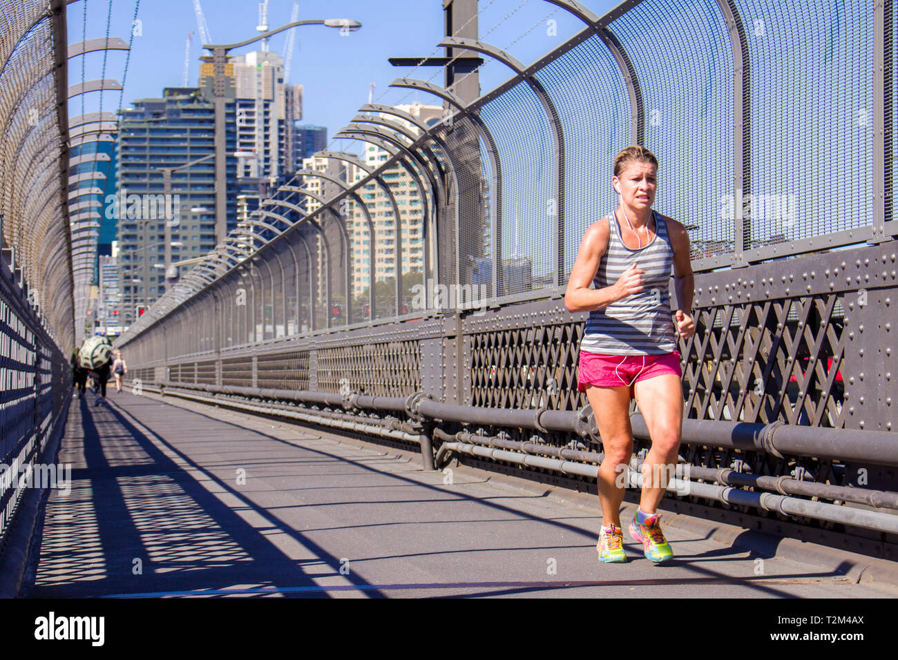 Jogger auf der Harbour Bridge in Sydney, Australien. an einem sonnigen Tag. Das ist ein guter Ort für Training an einem Sonntag Morgen, wo Sydney Opera House Stockfoto