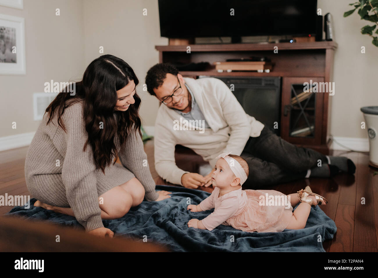 Paar mit Baby im Wohnzimmer Stockfoto