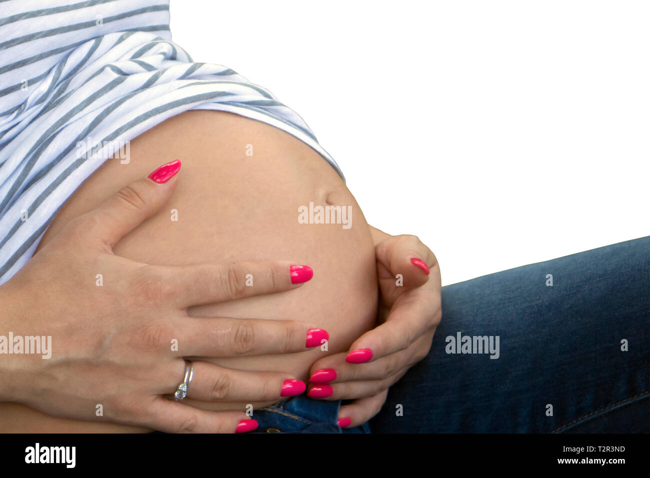 Cute schwangeren Bauch und Frau Hände mit gepflegten Nägel auf sie isoliert auf weißem Hintergrund Stockfoto