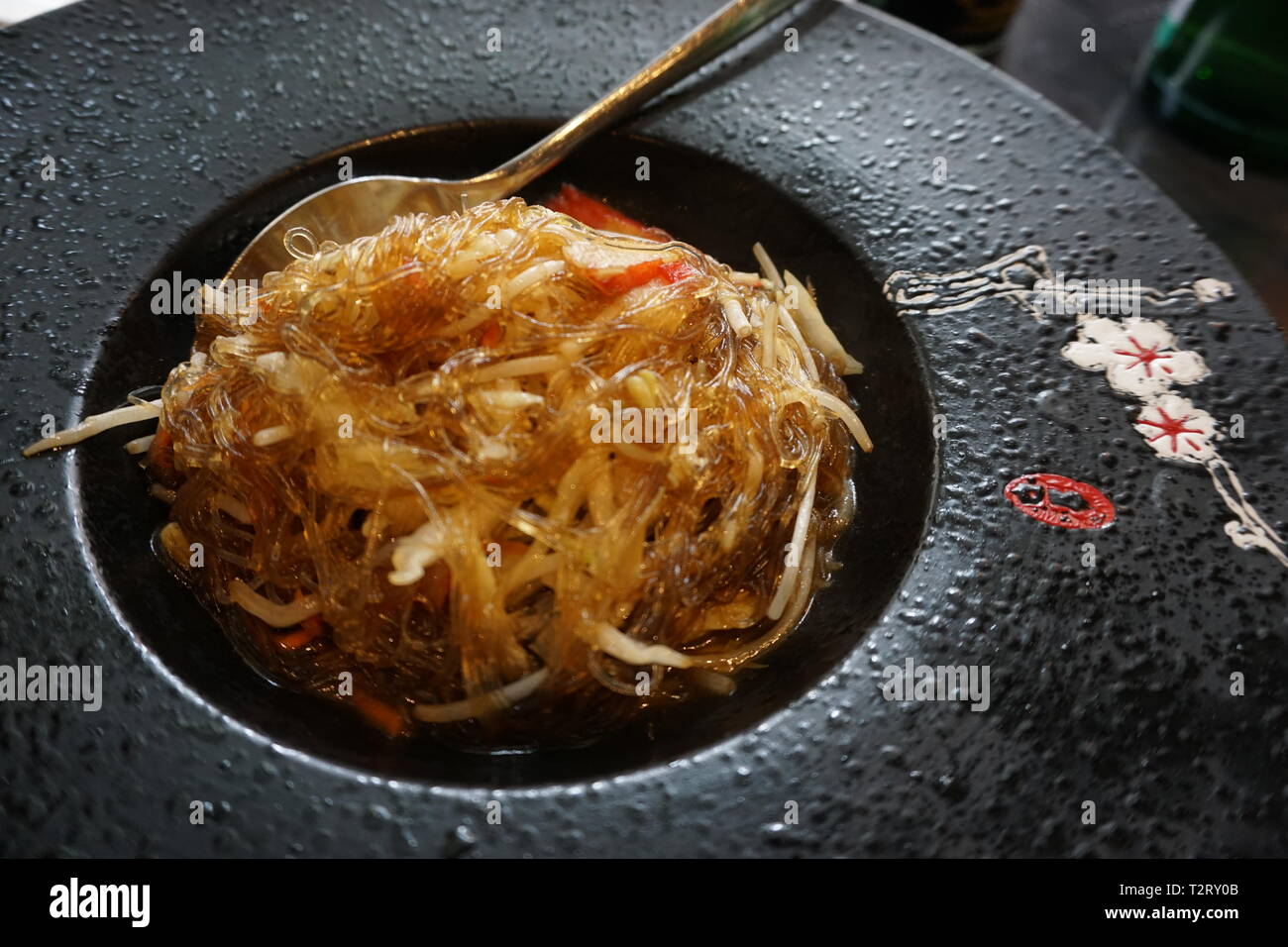 Chinesische Soja Nudeln in einem schwarzen Teller Stockfoto