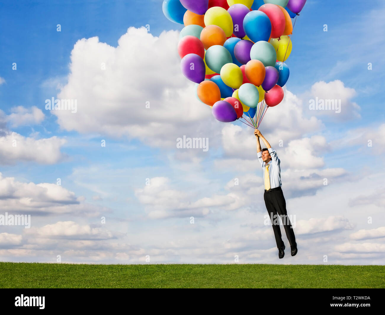 Unternehmer, die holding Helium Luftballons Stockfoto
