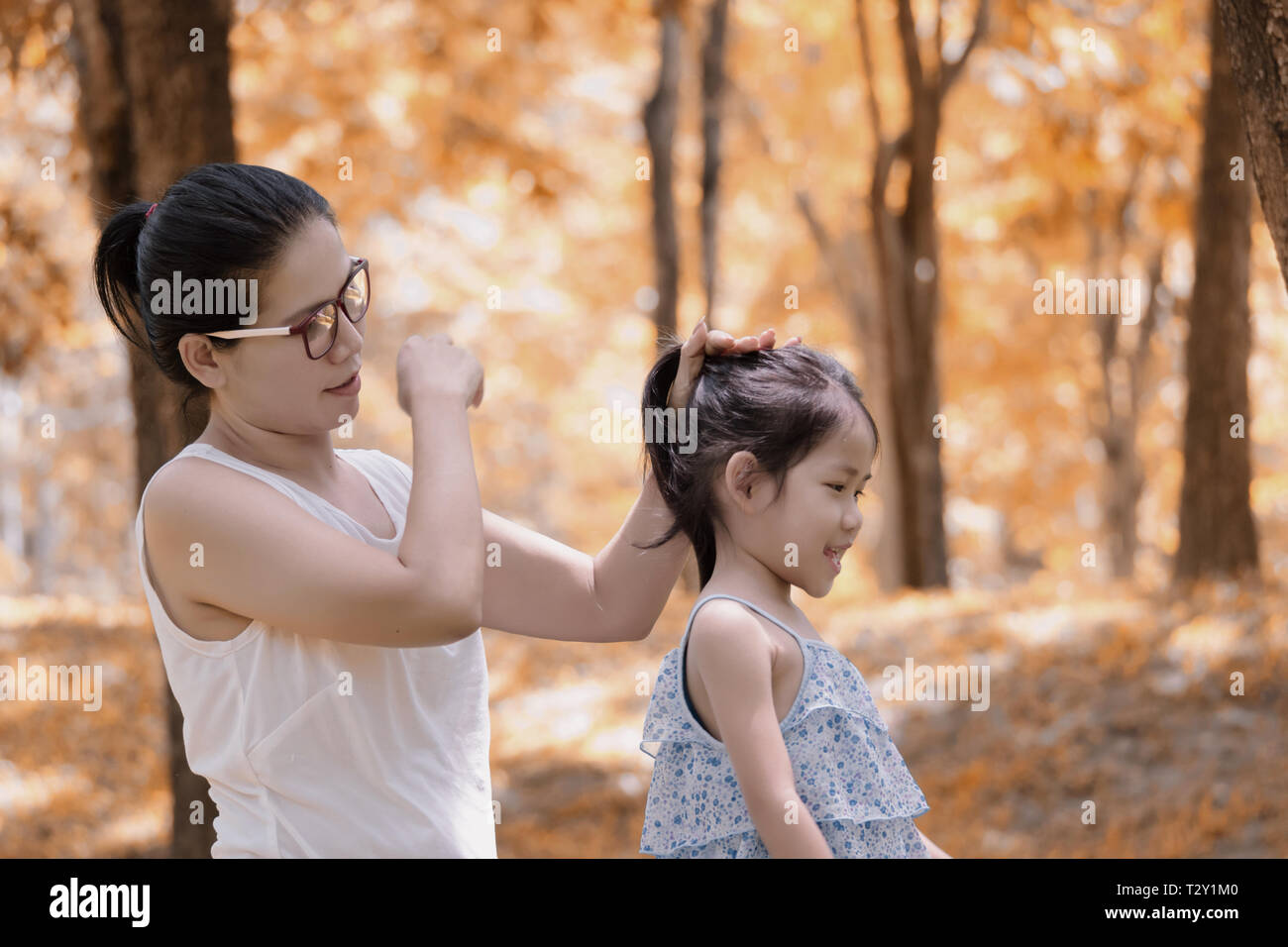 Mutter ist styling Töchter Haar im Freien Stockfoto