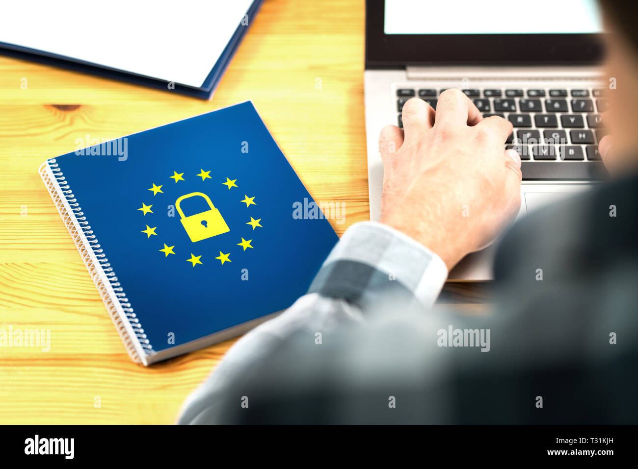 GDPR-Konzept (Allgemeine Datenschutzverordnung). Business man schreibt eine E-Mail mit Laptop. Notizbuch mit EU-Flaggenlogo und Schlosssymbol. Stockfoto