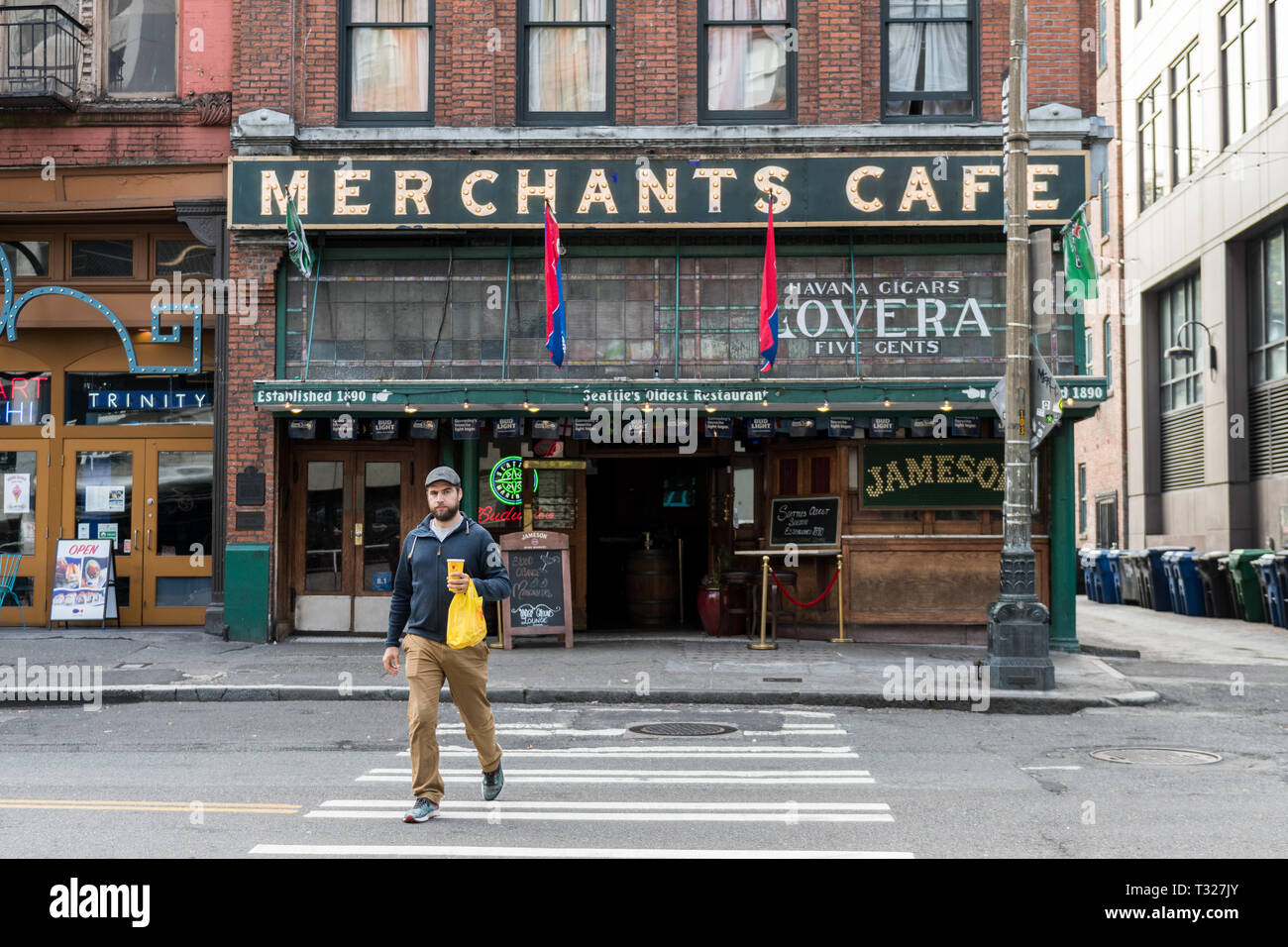 Ein junger Mann vor der Kaufleute Cafe, die älteste Bar in Seattle, Washington, USA. Stockfoto