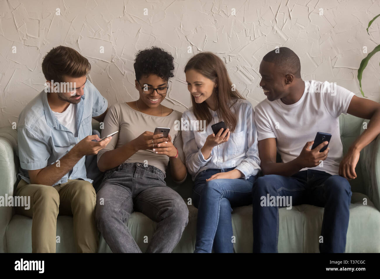 Gerne diverse Freunde Gruppe sharing Social Media News holding Telefone Stockfoto