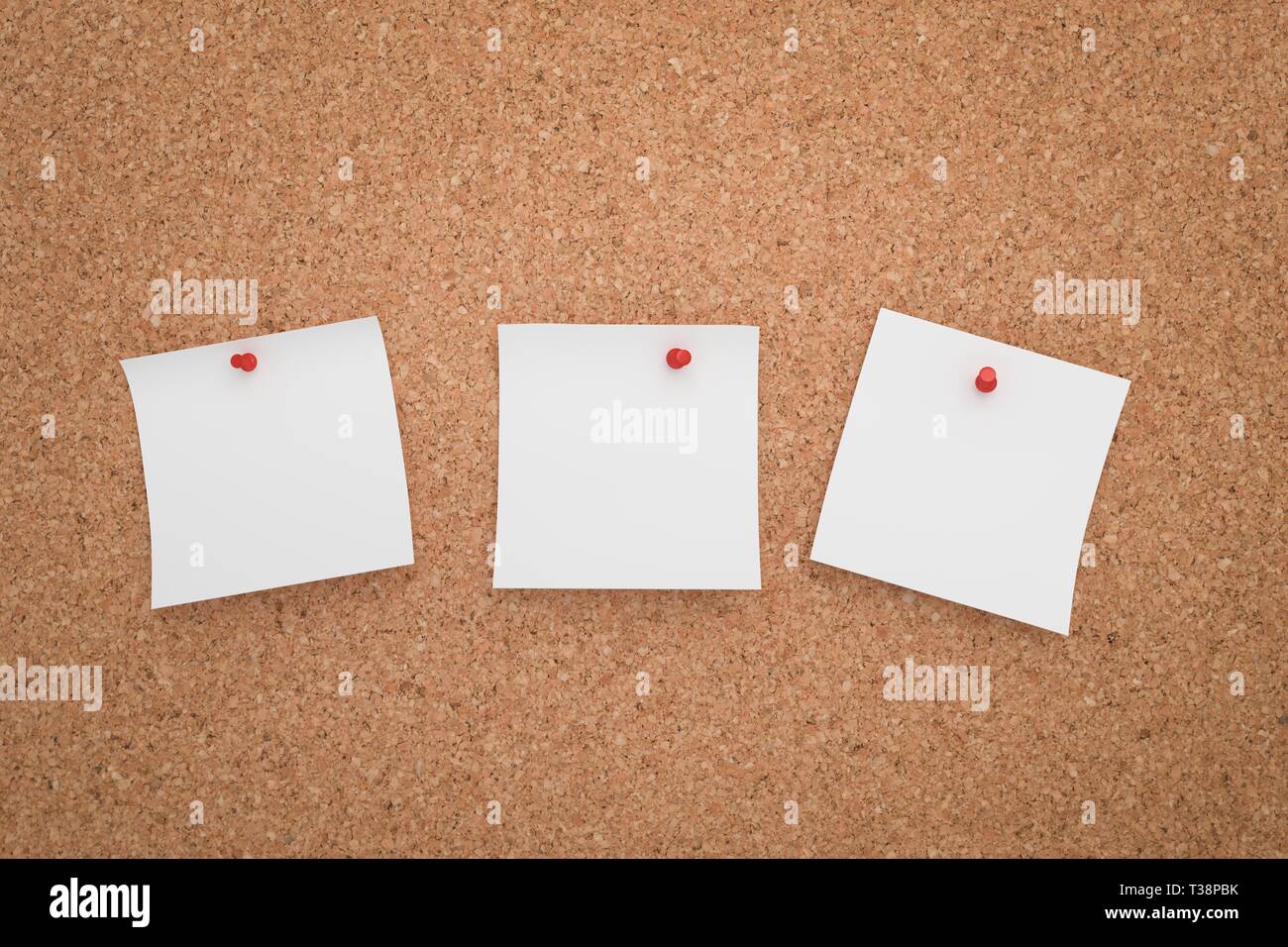 Drei weißen Aufkleber auf einer Pinnwand angeheftet. Stockfoto