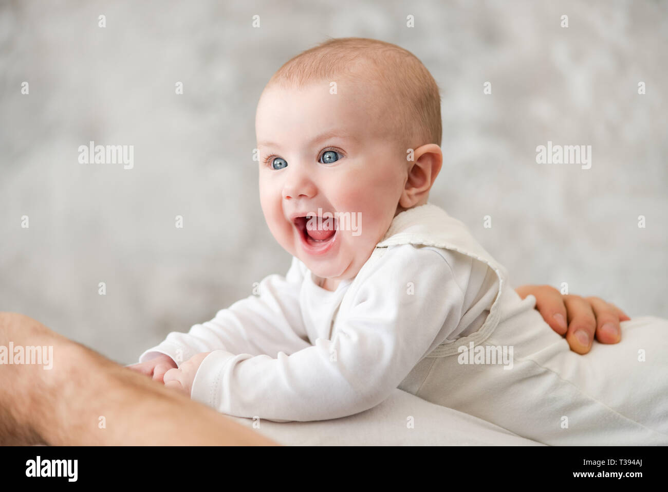 Portrait von lachendes Baby mit blauen Augen Stockfoto
