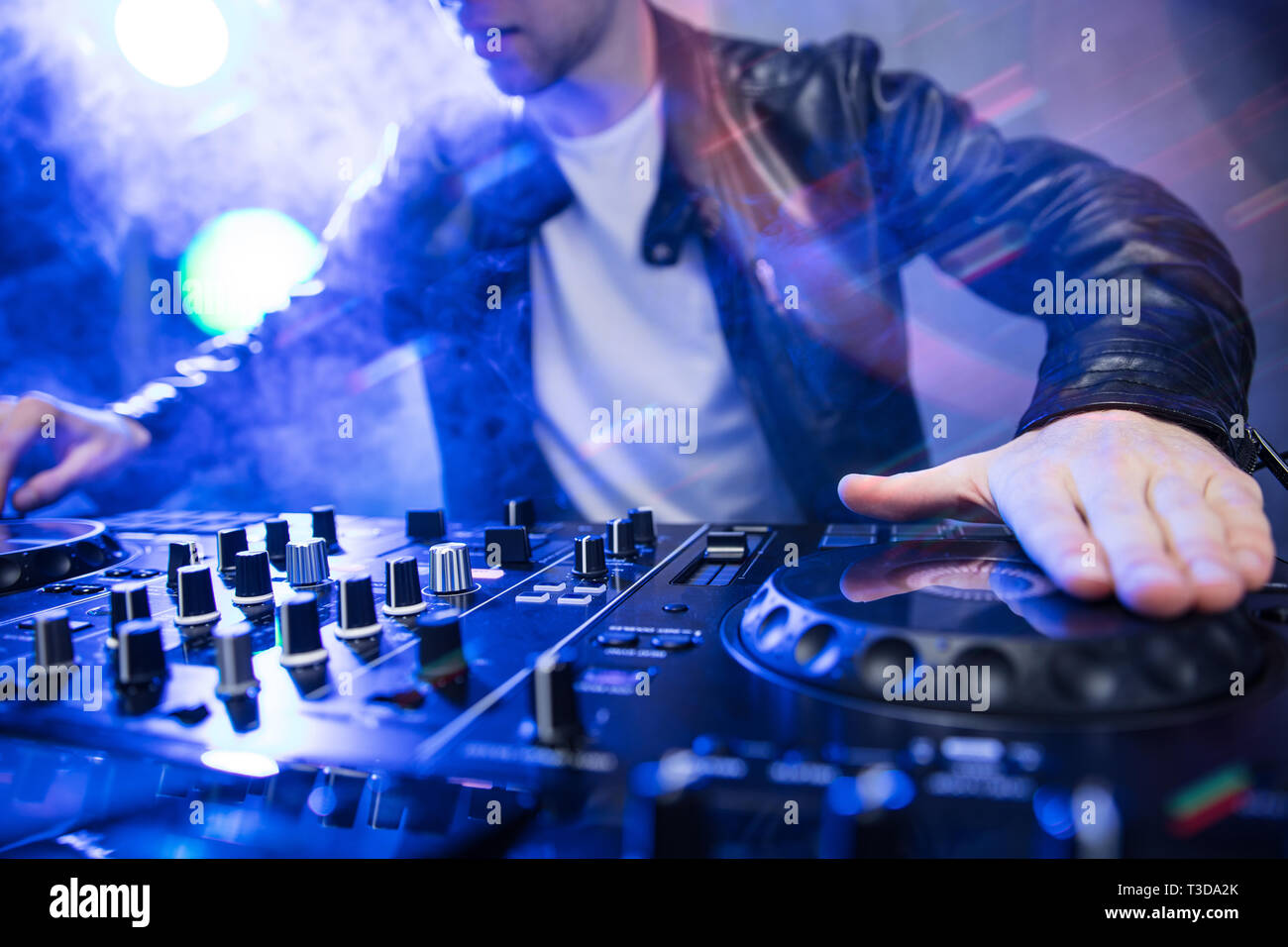 Dj-mixing bei Party Festival mit rotem Licht und Rauch im Hintergrund - sommerliche Nachtleben Blick auf disco club im Inneren. Fokus auf der Hand Stockfoto