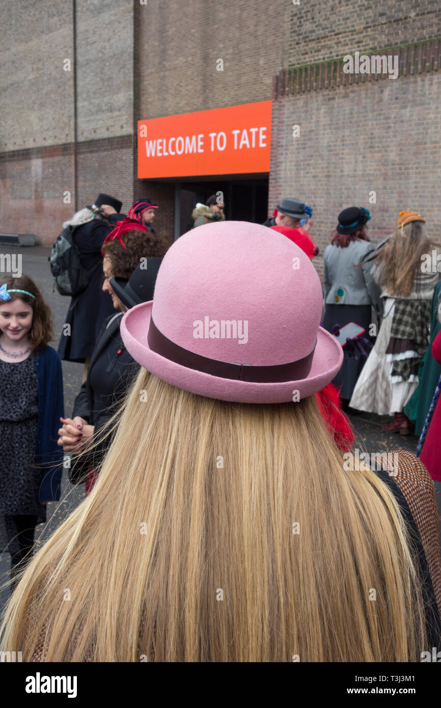Rückansicht einer blonden Frau mit pinkfarbenem Bowler-Hut als Teil des London hat Walk von der Tate Modern zur Tower Bridge, London, England, Großbritannien Stockfoto