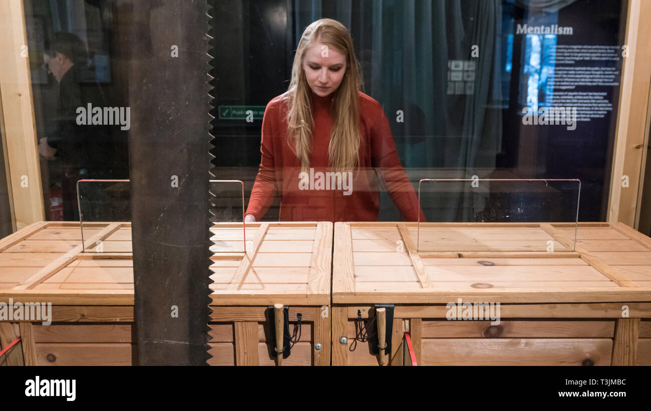 London, Großbritannien. 10 Apr, 2019. Ein Mitarbeiter stellt mit der awing durch eine Frau, 20. Jahrhundert, die von Paul Daniels und Debbie McGee, ein Nachbau des 1921 Original entworfen von PT Selbit verwendet. Vorschau von "Rauch und Spiegel: Die Psychologie der Magie", eine neue Ausstellung in der Wellcome Collection und die Erste, die überhaupt auf die Beziehung zwischen Magie und Psychologie zu konzentrieren. Die Ausstellung läuft vom 11. April bis 15. September 2019. Credit: Stephen Chung/Alamy leben Nachrichten Stockfoto