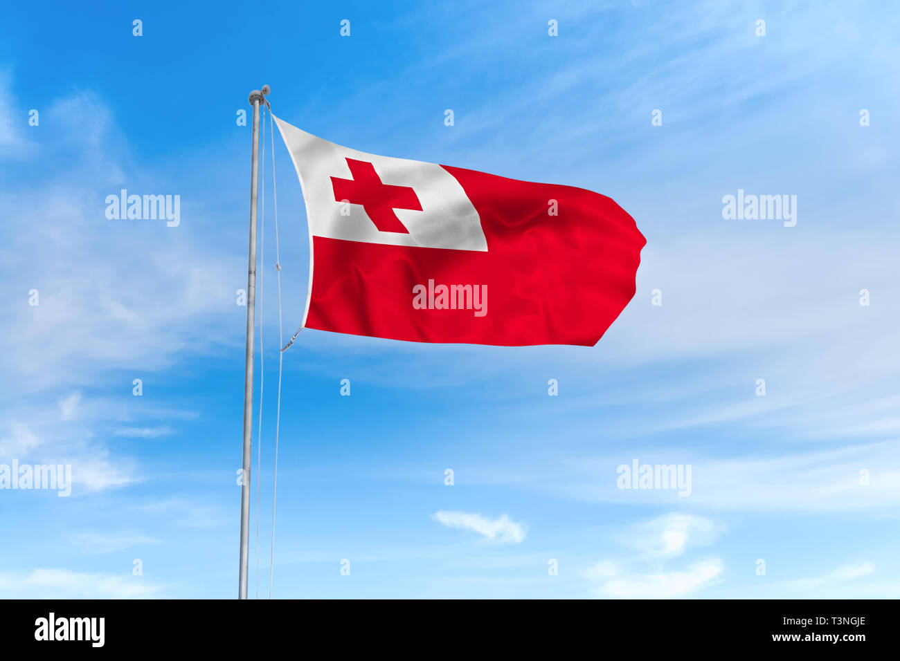 Tonga Flagge weht im Wind über blauen Himmel Hintergrund Stockfoto