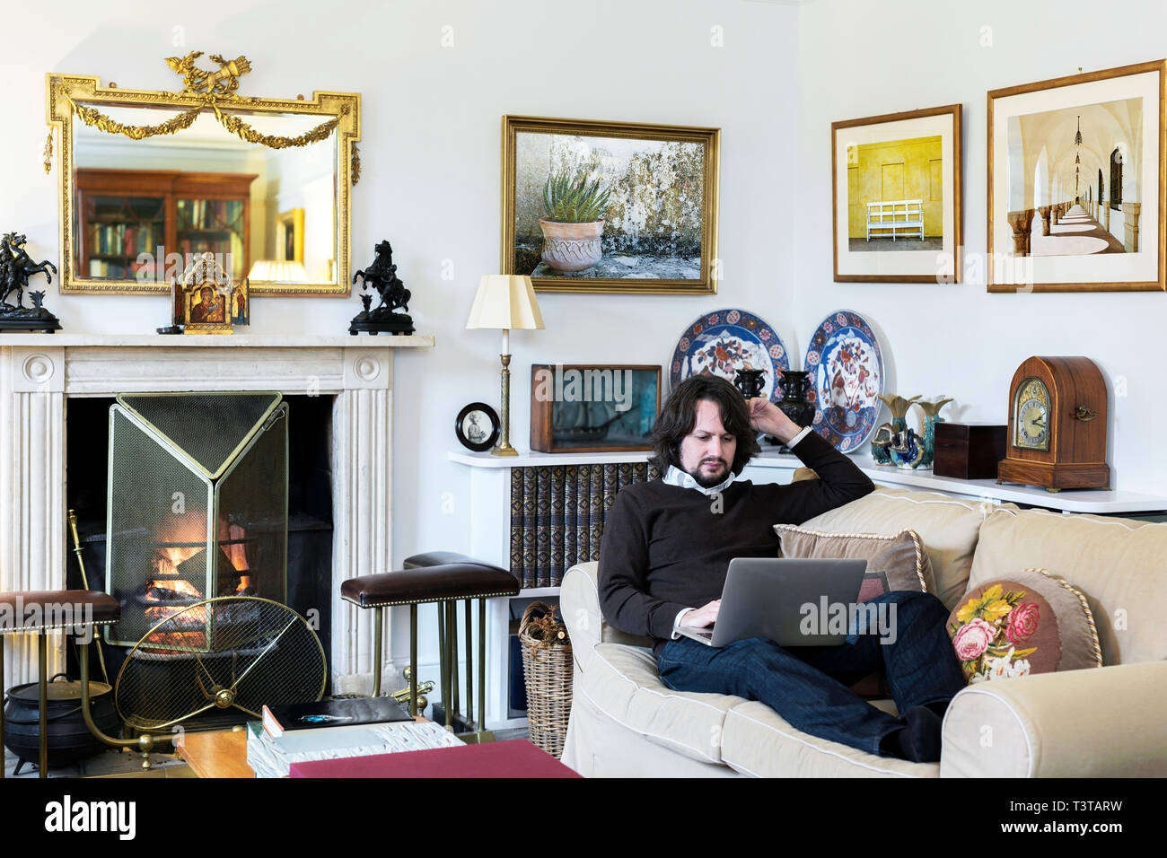 Kaukasischen Mann auf Sofa mit laptop Stockfoto