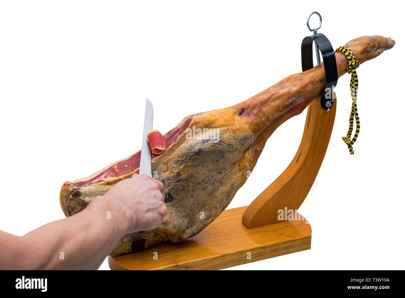 Hand schneidet mit dem Messer an einer spanischen Serrano Schinken in einem Holz-Halter - isoliert Stockfoto