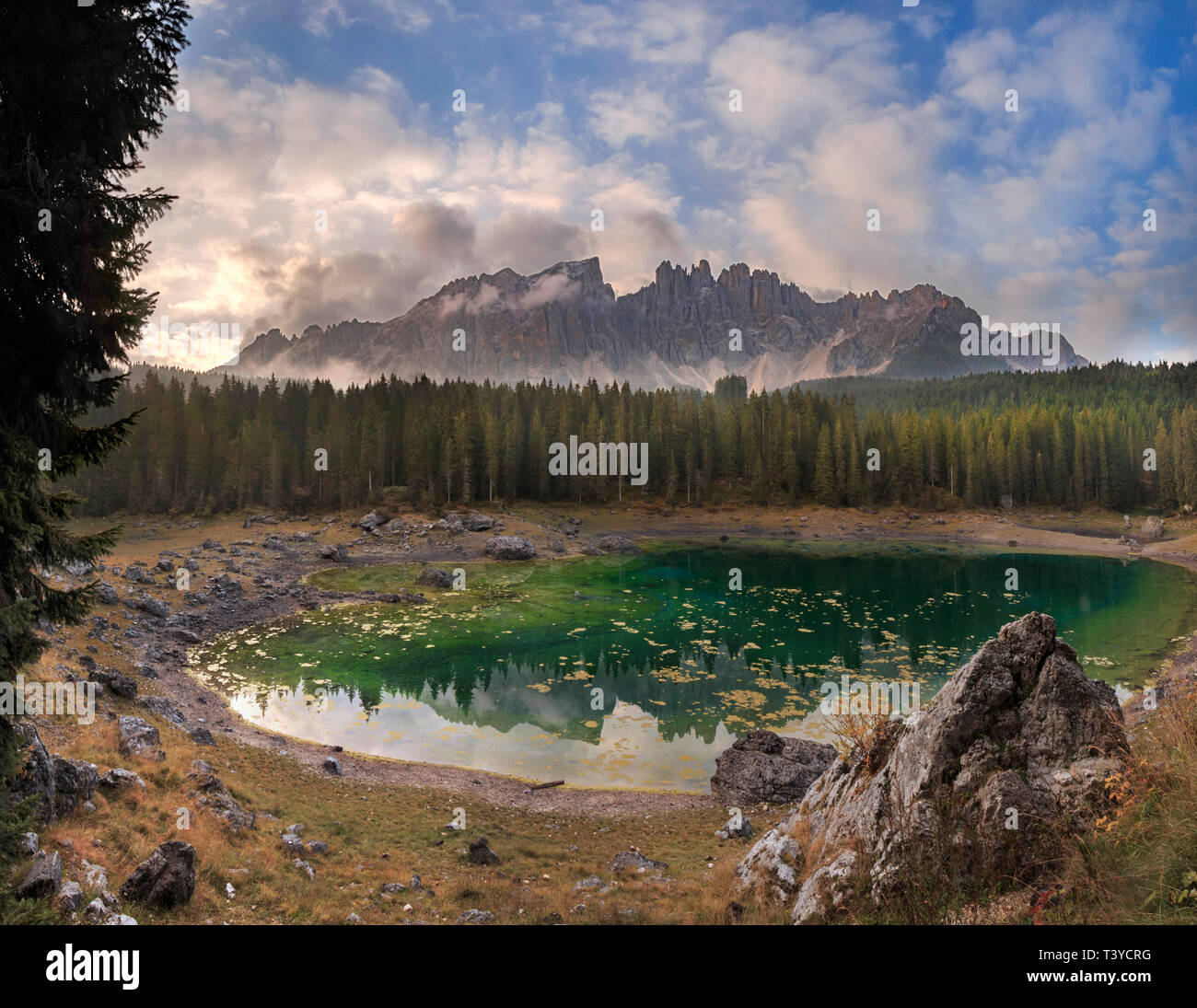 Ein herrlicher Sonnenaufgang am Karersee, ein wunderbarer See von zwei der bekanntesten Bergmassive der Dolomiten, Rosengarten & Ros umgeben Stockfoto