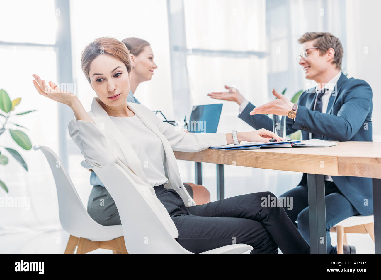 Attraktive emotionale Recruiter Gestik, die in der Nähe von Mann in Gläser Sprechen während der Arbeit Interview Stockfoto