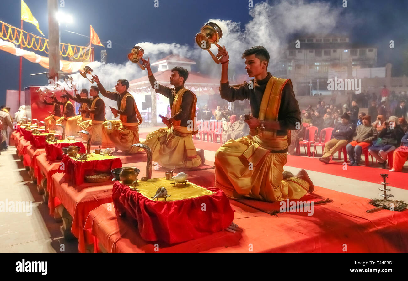 Jungen Hindu Priester führen traditionelle Ganga Aarti Zeremonie Rituale mit Feuer vor Sonnenaufgang auf dem Ganges in Varanasi, Indien. Stockfoto