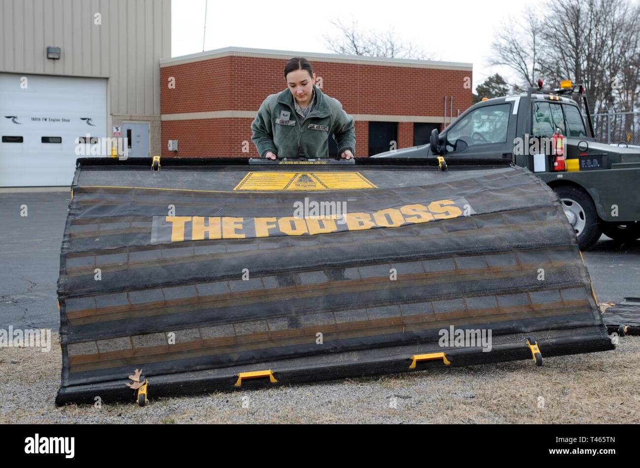 Senior Airman Haelie Egbert, eine Aerospace propulsion Techniker 180 des Ohio Air National Guard Fighter Wing zugeordnet, Reinigt Schmutz und Ablagerungen von speziell entwickelten Panels zu löschen Flugzeug Parkplätze und Rollwege der kleine Fremdkörper wie Steine und Stöcke, 3. März 2019. Ihre Rolle als F-16 Jet Engine Mechaniker ist Pratt & Whitney der Flügel 229 Motoren durch Zeit- Inspektionen, Reparaturen und Testläufe, die Bereitstellung hochwertiger Motoren, die für die Mission, während die Gewährleistung der Sicherheit der Piloten. 2019, die 180 FW wird Frauen in der Luftfahrt feiern, alkoholgradation Stockfoto