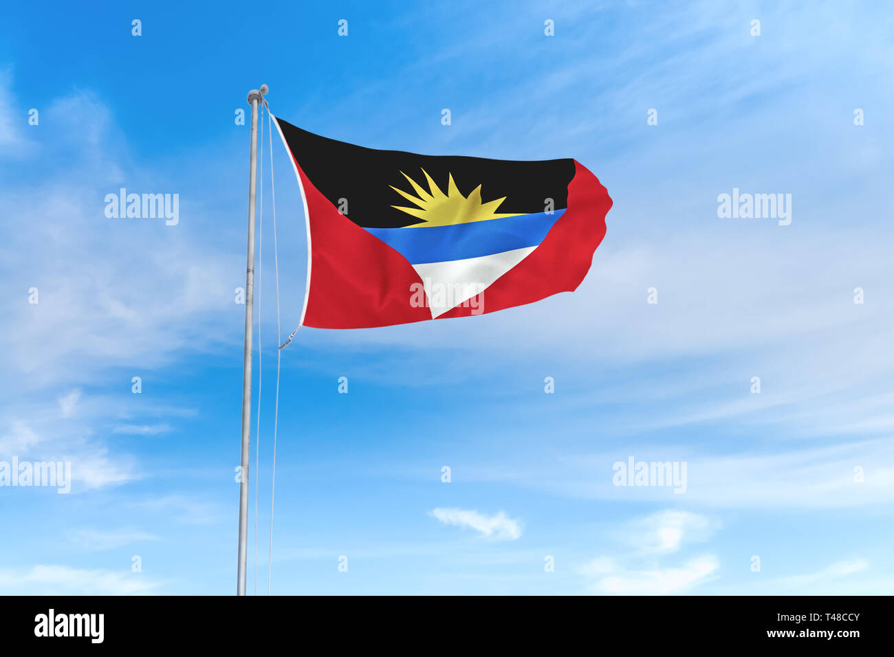 Antigua und Barbuda Flagge weht im Wind über blauen Himmel Hintergrund Stockfoto