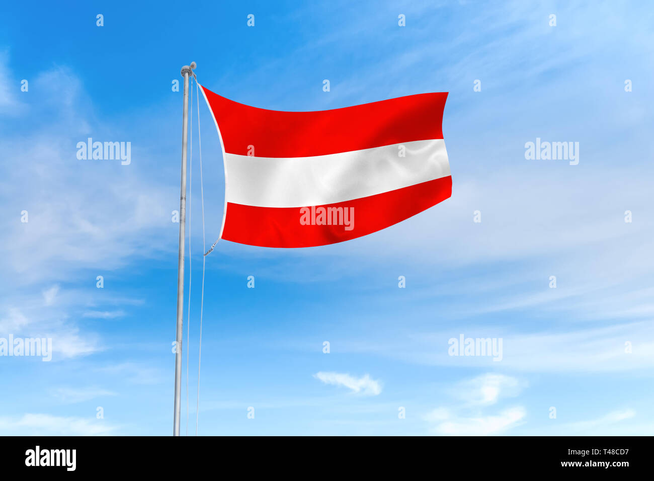 Österreich Flagge weht im Wind über blauen Himmel Hintergrund Stockfoto