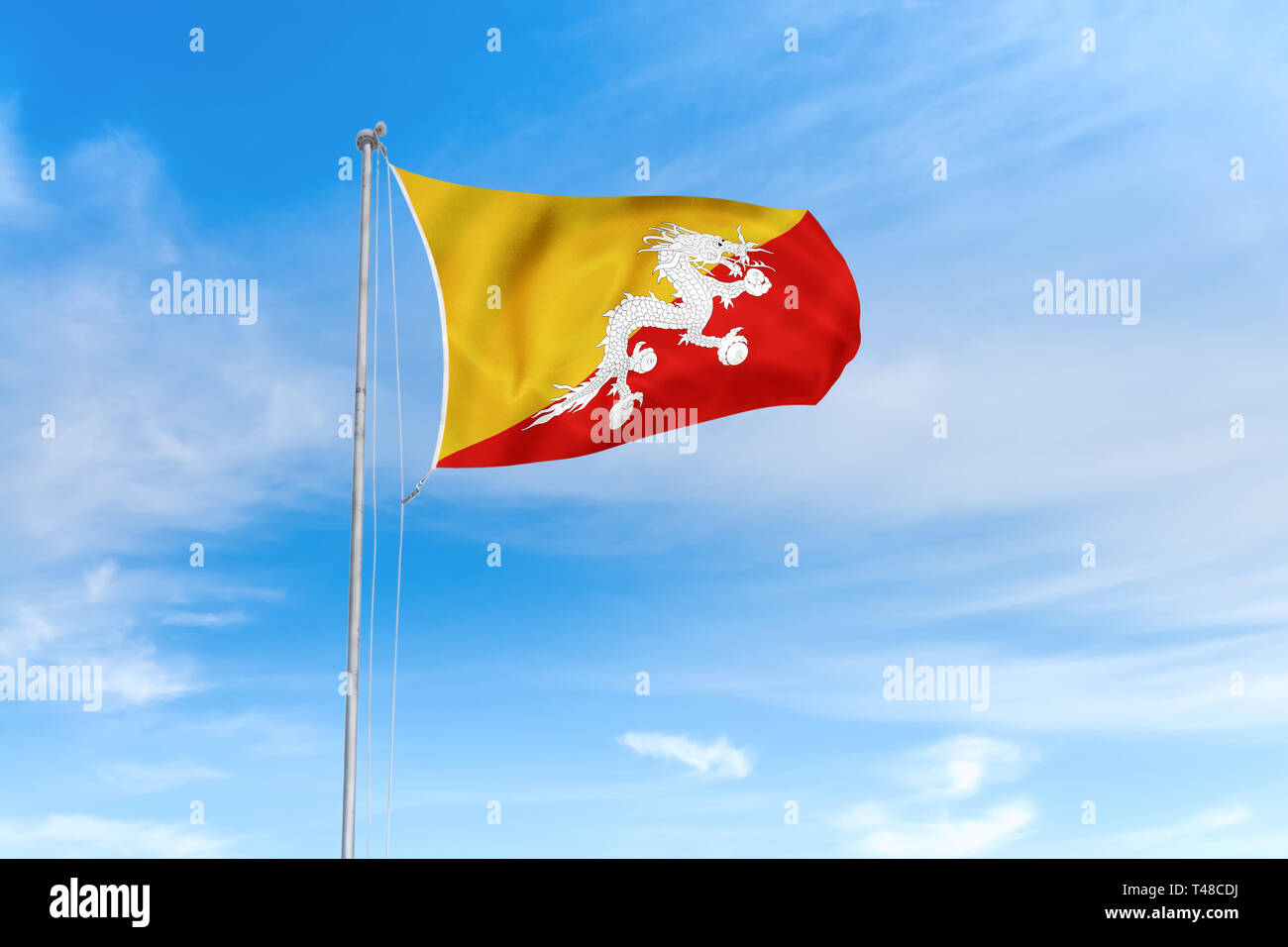 Bhutan Flagge weht im Wind über blauen Himmel Hintergrund Stockfoto