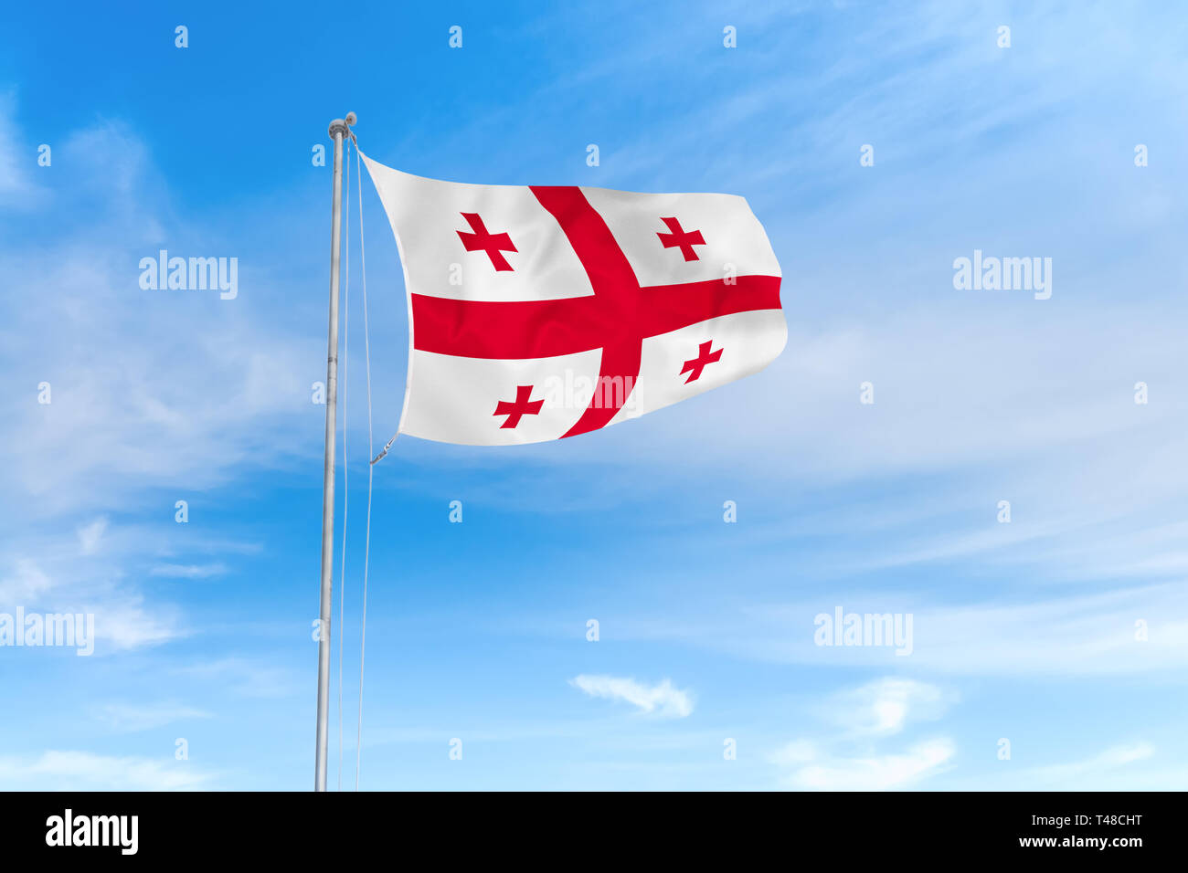 Georgia Flagge weht im Wind über blauen Himmel Hintergrund Stockfoto