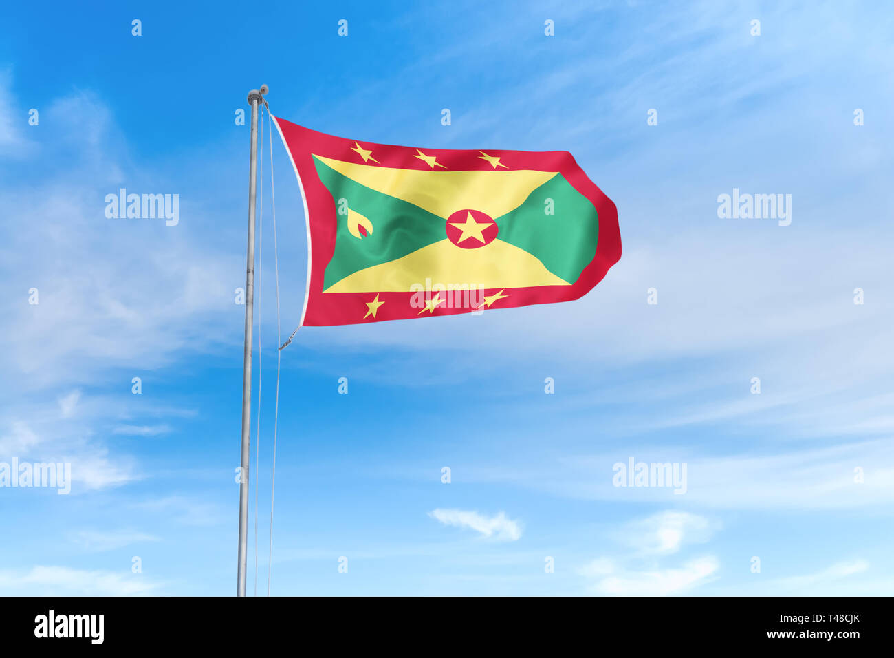 Grenada Fahne weht im Wind über blauen Himmel Hintergrund Stockfoto