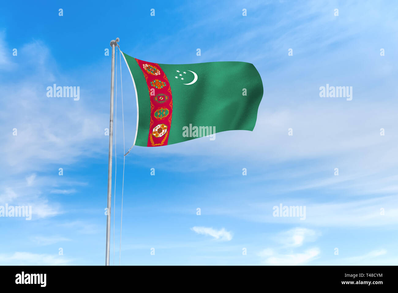 Turkmenistan Flagge weht im Wind über blauen Himmel Hintergrund Stockfoto