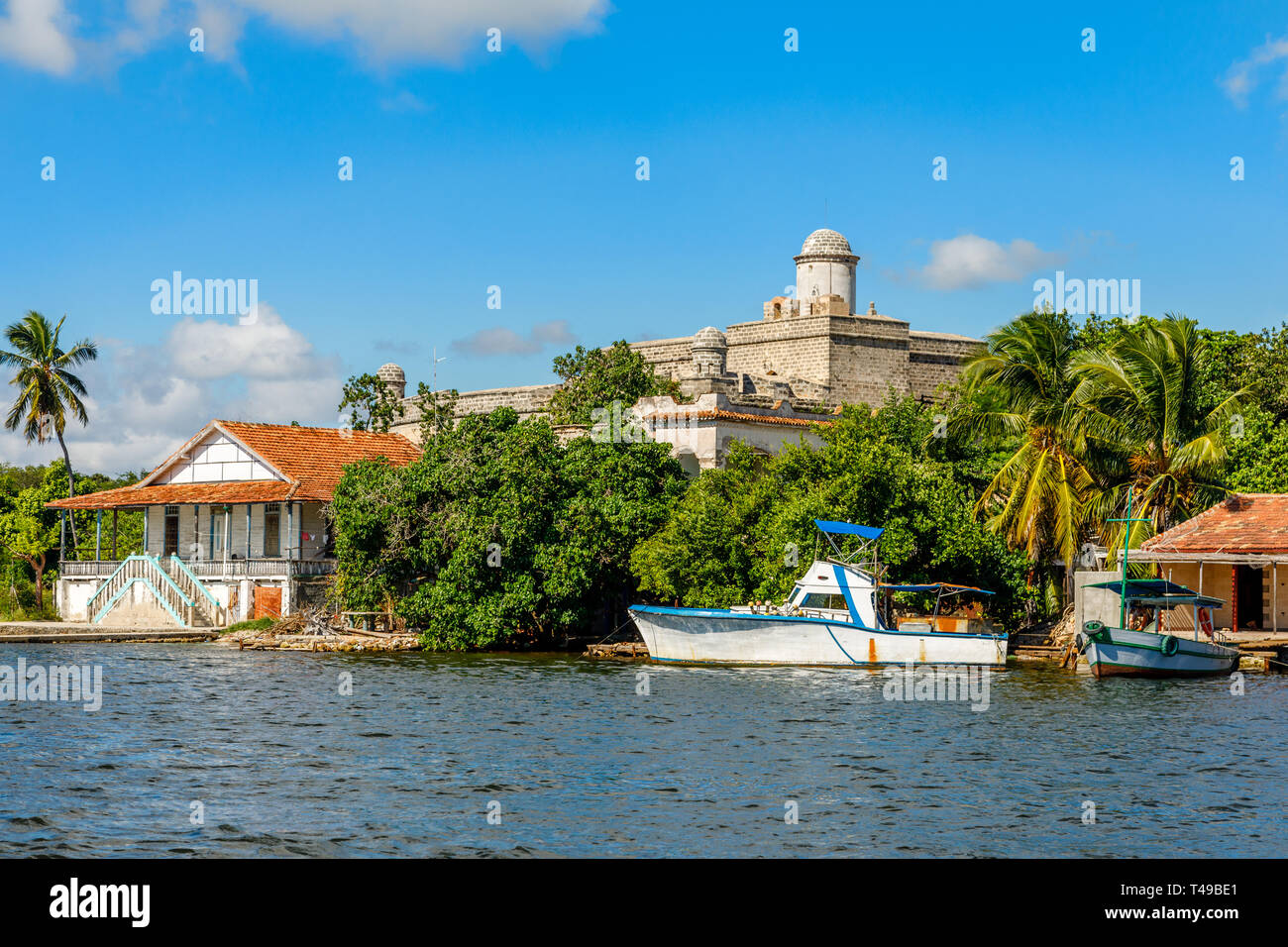 Jagua Spanische Festung Festungsmauern mit Bäumen und Fischerboote im Vordergrund, in der Provinz Cienfuegos, Kuba Stockfoto