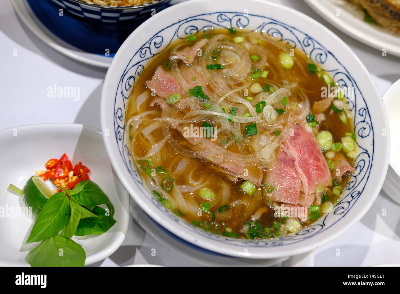 Reis Nudeln mit in Scheiben geschnittenen rohes Rindfleisch in Kalbfleisch (vietnamesische Nudelsuppe pho Rindfleisch) Stockfoto