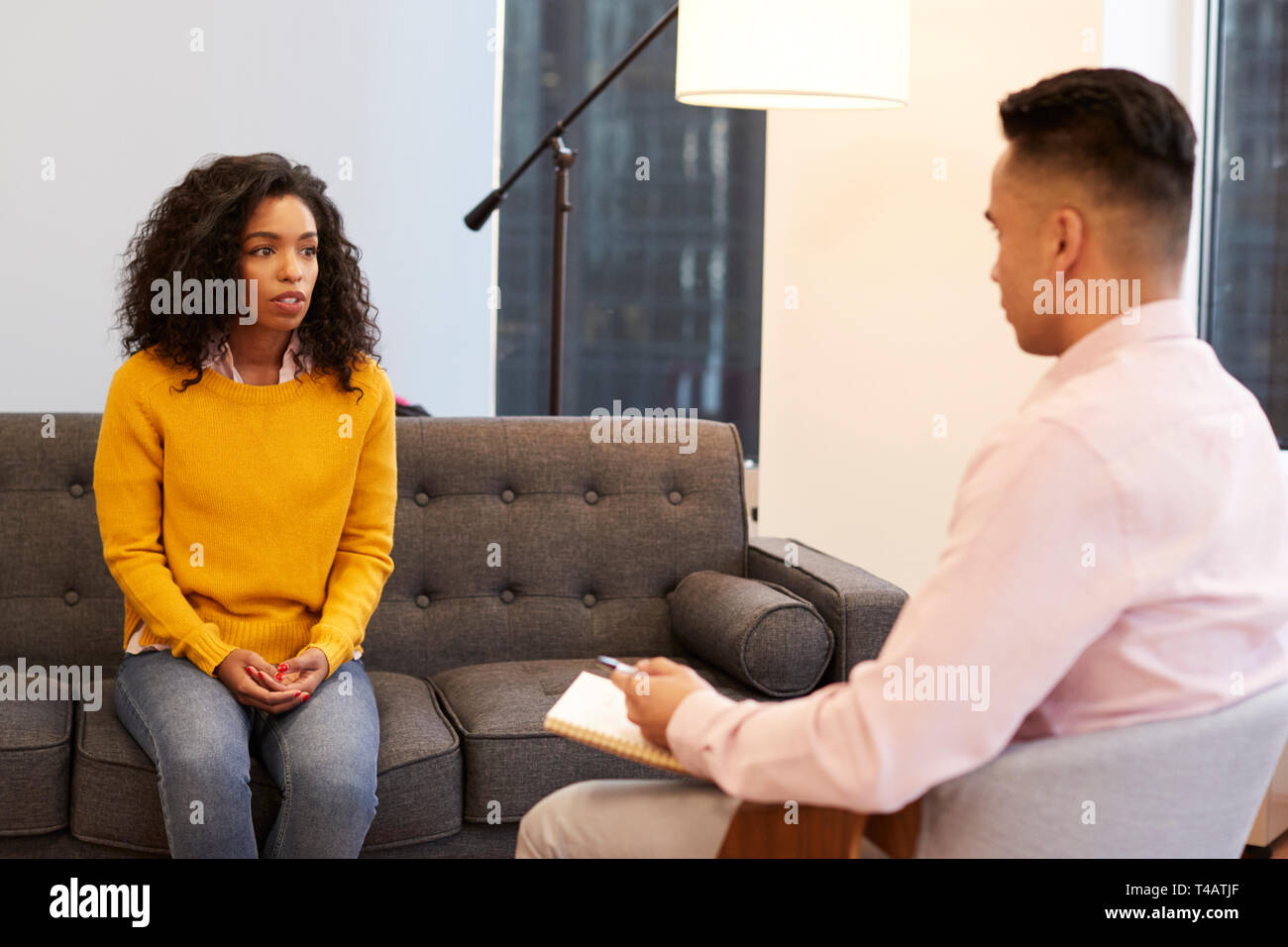 Frau sitzt auf der Couch treffen mit männlichen Ratgeber in Office Stockfoto
