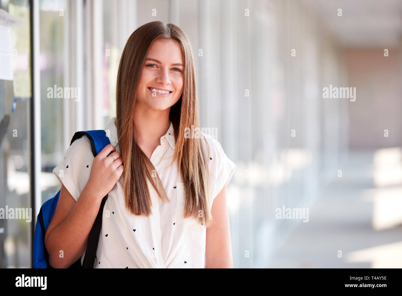 Portrait von Lächelnd weibliche Studenten mit Rucksack im Flur des Gebäudes Stockfoto
