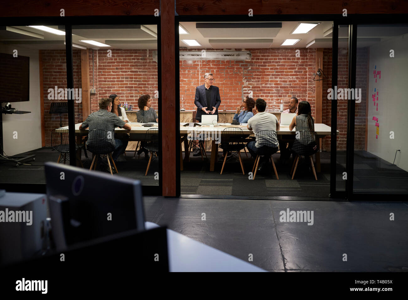 Business Team in spät in die Nacht treffen Sitzen um Konferenztisch Stockfoto