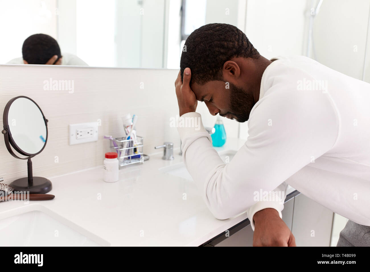 Betätigt man stützte sich auf das Waschbecken im Badezimmer mit Kopf in den Händen Stockfoto