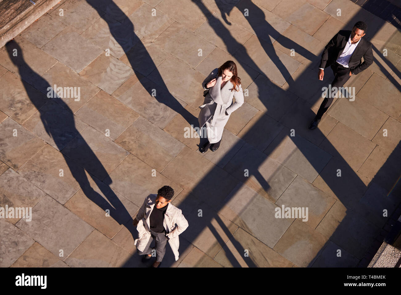 Luftaufnahme von drei Geschäftsleute gehen in die gleiche Richtung an einem sonnigen Urban Street, horizontal Stockfoto