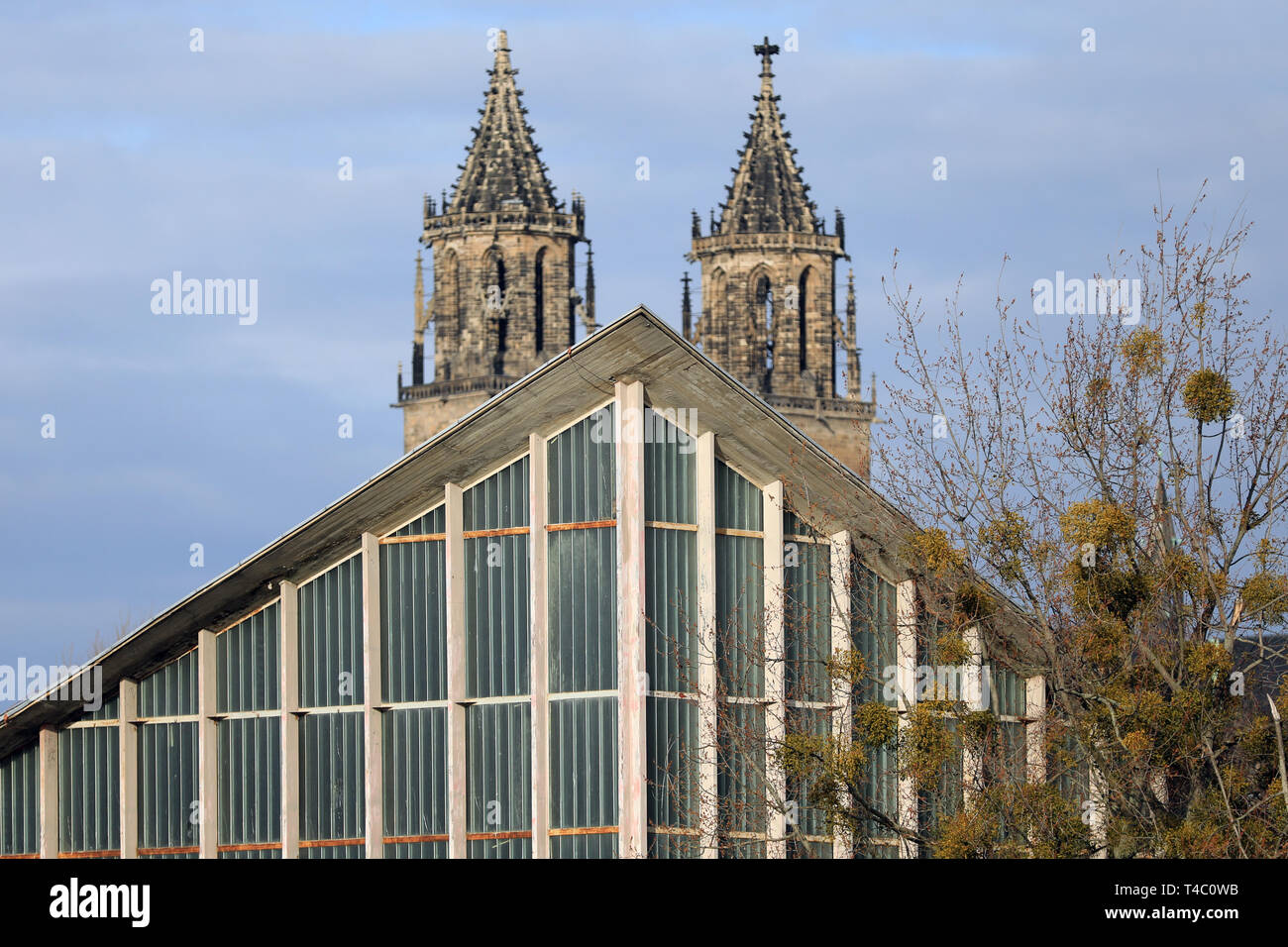 Magdeburg, Deutschland. 12 Feb, 2019. Die beiden Türme der Kathedrale steigen über die Giebel der "Hyparschale" in der Rotehorn Stadtpark. Für die Freie 45 Jahre alten shell Gebäude des Architekten Ulrich Müther, neue Verwendung Entwürfe werden im Rahmen einer Ausstellung sah. Credit: Peter Gercke/dpa-Zentralbild/ZB/dpa/Alamy leben Nachrichten Stockfoto